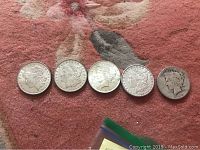 Obverse view of all five coins aligned.