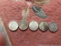 Five coins showing obverse (Lady Liberty)