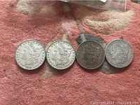Obverse of four Morgan dollars, dates visible left to right: 1881, 1880, 1881, 1879