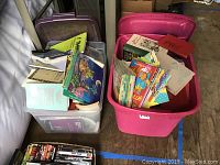 Two large plastic bins of assorted books including children's and adult books, various subjects.