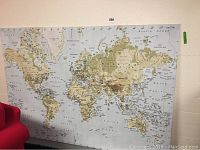 Front view of the large canvas atlas wall art showing entire world map with detailed geographical names.