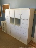 Front view of full cabinet showing doors, drawers and open cubbies