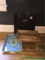 Four service trays stacked together with visible designs and colors.