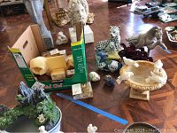 Photo showing alabaster birdbath with birds on rim plus various animal and bird figurines including snow leopard, horses, and Marjorie Bastin birds.