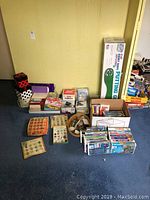 Wide shot of lot including mini putting green, VHS tapes, rock collections, stationary and gift boxes lined against a wall.