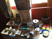 Overview of assortment on table including jewelry, figurines, boxes, and watches