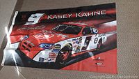 Full view of the Kasey Kahne Dodge NASCAR flag showing the racecar image, number 9, and signature.