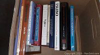 Photo showing 13 hardcover books on acupuncture and Oriental medicine placed side by side in a box with visible titles on spines.