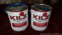 Two 1-gallon cans of KILZ Original interior primer side by side showing label and condition.
