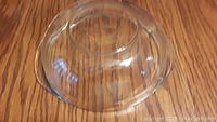 View of the bottom of the glass baking bowl showing the curved base and foot ring.
