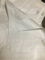 Folded set of napkins showing damask border pattern and original labels visible