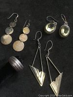 Photo showing all four pieces: three pairs of sterling silver earrings and one ridged silver ring.