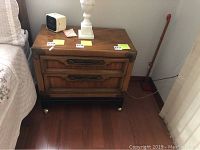 Pair of wooden end tables beside beds.