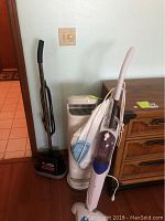 Full view of Hoover vacuum, Pure Ion tower fan and H2O steam mop standing together