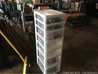 Tall white plastic storage unit with 7 drawers containing Lego pieces