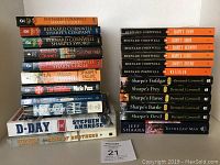 Photo showing all 17 books stacked with visible titles including 16 Bernard Cornwell Sharpe's novels and other authors such as Stephen Ambrose and Jeff Shaara.