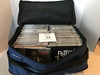 Front view of zippered case open showing rows of CDs inside