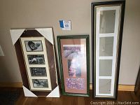 Three multi-opening photo frames standing against a beige wall; one black frame with gold trim, one green frame with three photos, one wrapped frame with four openings.