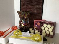 Lot items arranged showing table runner, mosaic candle holder, watering bulbs, decorative box with votives, and bud vase