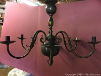 Full view of the 6-light metal chandelier showing six curved arms and overall structure