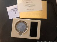 Estee Lauder Pegasus Lucidity powder compact in fitted foam insert alongside velvet pouch, original sleeve, and gold box. Informational card about Pegasus constellation collection visible.