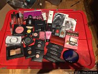 Top-down view of all items arranged on red bin lid