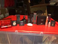 All makeup items displayed on a red container with visible boxes and product tubes.