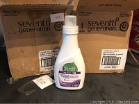 Two cardboard cases each labeled Seventh Generation fabric softener, six bottles per case with one bottle outside the cases showing the label.