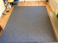 Rug laid flat on wood floor showing full size and color.