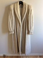 Front view of full-length mink coat on hanger