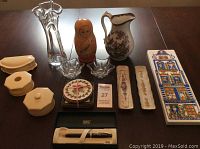 Wide shot of full lot including Russian nesting doll, French ivory boxes, porcelain decor, glass dishes, and Cross pen.