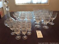 Full view of the crystal stemware set on table including glasses and decanter.