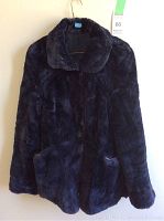 Front view with collar open showing button closure and two front pockets.