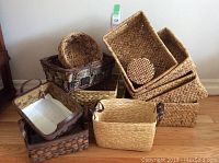 Overall view showing a variety of woven baskets of different shapes, colors, and sizes.