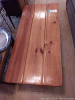 Top view of the solid pine coffee table showing three wooden planks and natural wood grain.