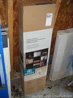 Photo of the boxed storage organizer showing product dimensions and brand labeling.