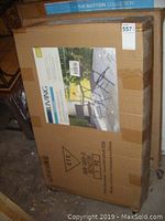 Photo showing packaging box with sticker and partial product image, listing the item as The Sutton Collection, folding bistro set.
