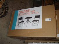 Photo of boxed 3 piece bistro set showing product image on box.