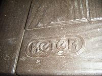 Close-up of Keter logo embossed on the lid of the resin storage box showing brand detail.