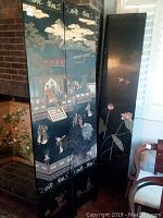 Room divider shown mostly folded with painted traditional Asian figures and architectural scenes visible on three panels; black panels with light decorative edges.