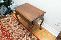 Top and side angle view of the Harden Mahogany side table showing the polished wood surface and cabriole legs.