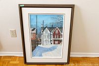Overall front view of framed watercolour painting showing two houses and snow-covered foreground