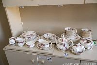 Full set arranged on shelf showing plates, bowls, teapot, tureen, cups and saucers