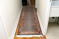 Full length view of Persian runner rug laid in hallway showing entire pattern