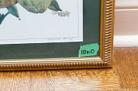 Close-up of the print showing the signature and 10x10 size label on the corner of the frame.