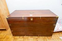 Front view of cedar chest showing stained wood exterior and recessed latch