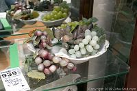 Photo showing the whole lot including the divided porcelain dish and five clusters of stone grapes in multiple colors.