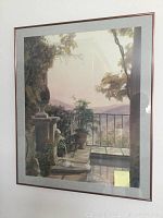 Four framed and matted landscape pictures with outdoor terrace scenes, stone elements, plants, and distant hills.