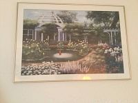 Framed garden scene featuring a fountain and dome structure surrounded by flowers and trees.