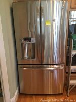 Front view of stainless steel French door refrigerator with bottom freezer drawer